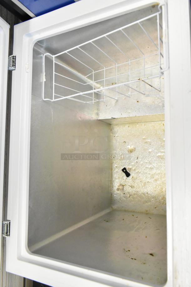 Hisense WFC070M6RWD chest freezer with hinge lid, 115 volts, 1 phase. Shows interior with metal finish and wire basket.