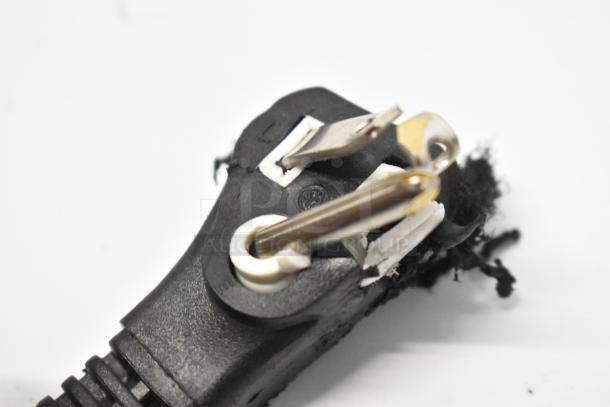 Close-up of a damaged power plug, possibly part of a Hisense WFC070M6RWD freezer. Plug shows fraying and exposure.