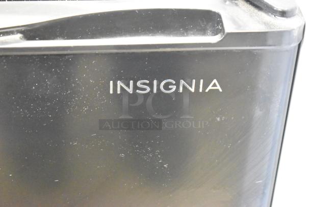 Insignia NS-CF26BK9 Mini Cooler, black finish, 115 Volts, 1 Phase. Appears gently used with visible brand name.