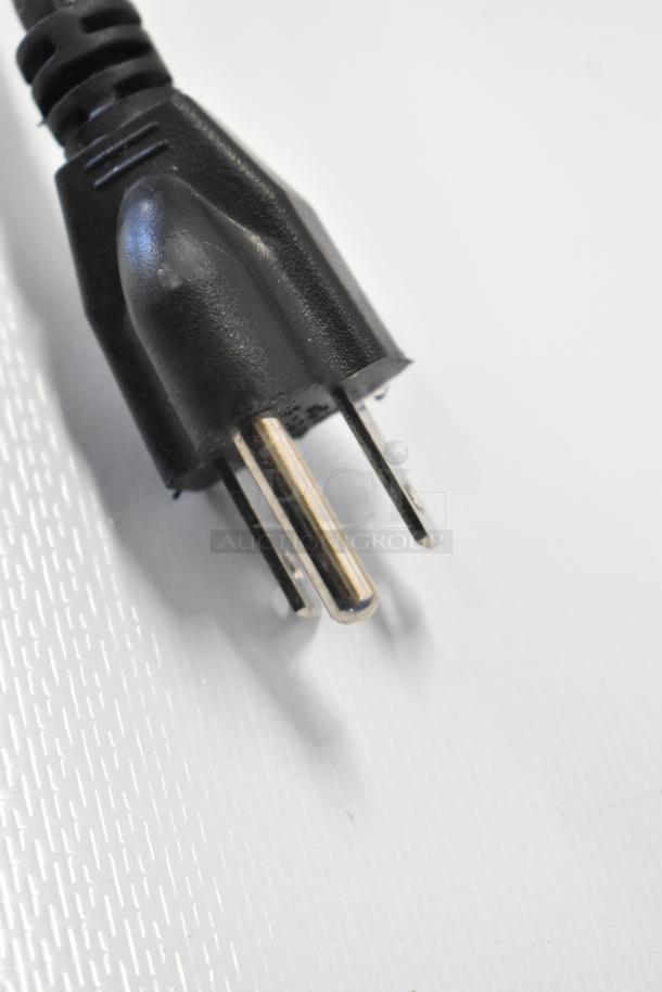 Close-up of the power plug for Insignia NS-CF26BK9 Mini Cooler, 115 Volts, 1 Phase. Black with three prongs.