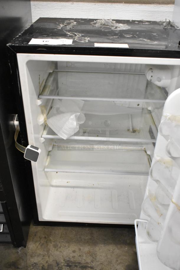 Insignia NS-CF26BK9 Mini Cooler, 115 Volts, 1 Phase, open interior view, used condition, signs of wear on top surface.