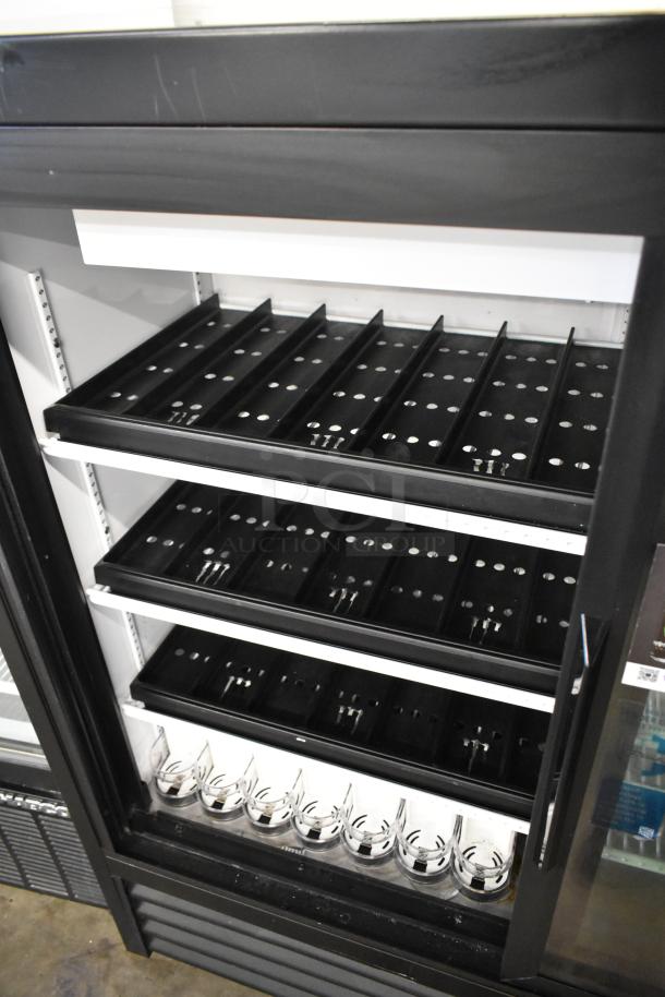 2024 True GDM-41SL-48-HC-LD commercial cooler with poly-coated racks, two doors, metal exterior, 115 volts, excellent condition.