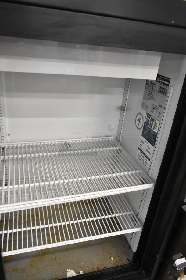 2024 True GDM-41SL-48-HC-LD commercial cooler with 2 doors, poly coated racks, and visible labels. 115 volts, 1 phase.