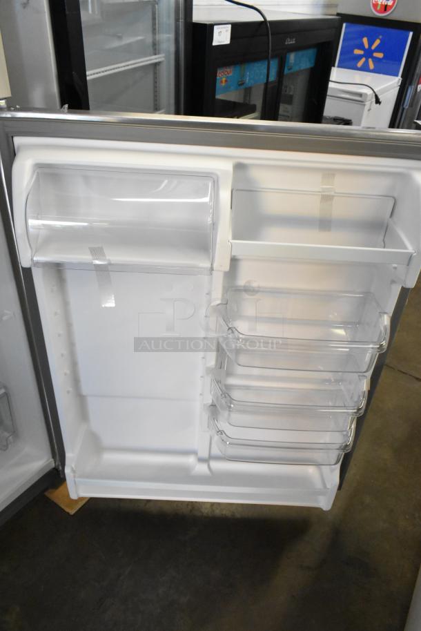 Brand new Whirlpool WRT311FZDM05 stainless steel cooler with freezer, 115 volts, 1 phase, shown with door open.
