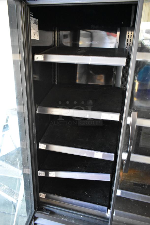 2022 True TVM-48SL-HC metal commercial 2-door reach-in cooler with metal shelves, 115 volts, 1 phase. Interior view.