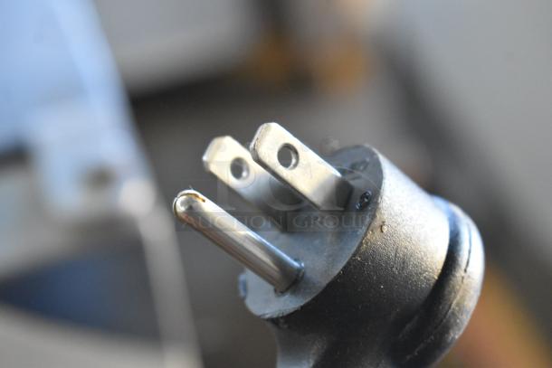 2022 True TVM-48SL-HC commercial cooler power plug, 115 volts, 1 phase. Close-up of three-pronged design.