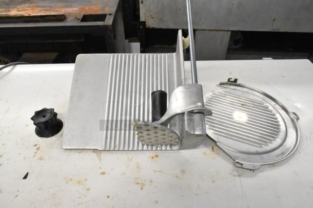 Hobart 1612 metal commercial countertop meat slicer, in used condition. Features rotary blade and adjustable thickness control.