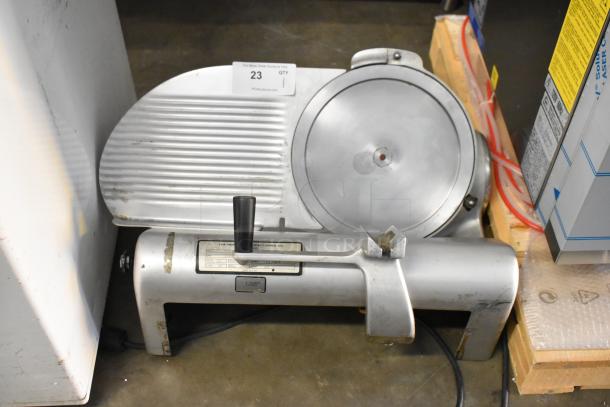 Hobart 1612 metal commercial meat slicer. Countertop model, 115 volts, 1 phase. Slight wear visible.