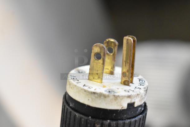 Close-up of an electric plug from a Hobart 1612 Meat Slicer, labeled "7.5A, 125V," with visible prongs and casing details.