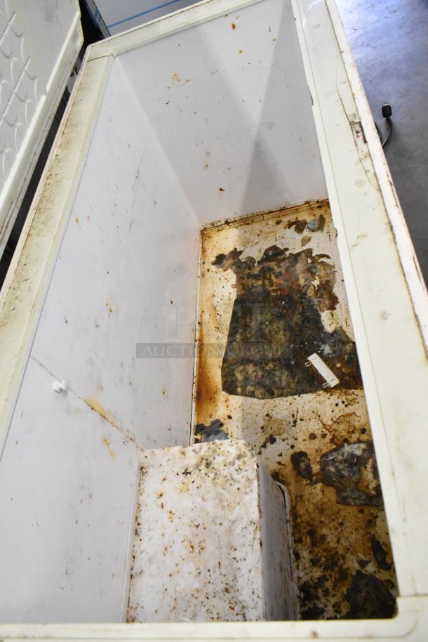 Bradford 61168 metal chest freezer with hinge lid, visible rust and wear, 115 volts, 1 phase, for repair or parts.