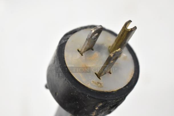 Close-up of a power plug for Bradford 61168 Metal Chest Freezer, 115 volts, 1 phase. Visible wear and oxidation.