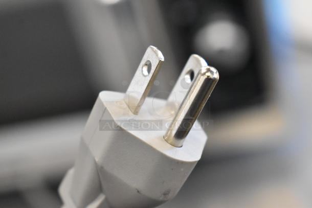Close-up of a power plug for the 2024 Midea 1025FOA Stainless Steel Commercial Countertop Microwave Oven.