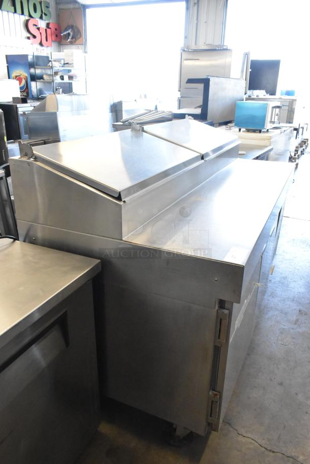 Stainless Steel Commercial Pizza Prep Table on casters, 115V, 1 Phase, excellent condition, with hinged top and storage.