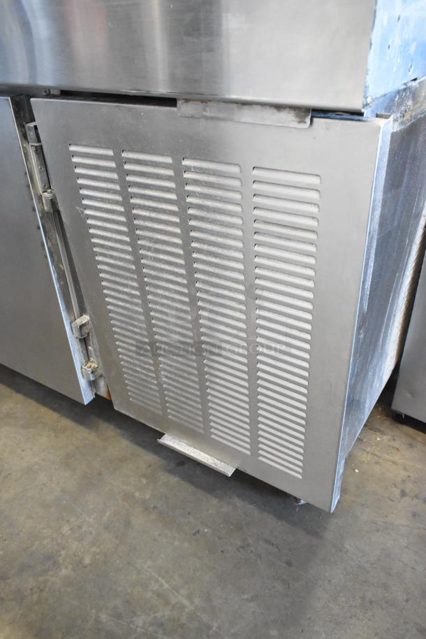 Stainless steel commercial pizza prep table with vented panel, on commercial casters. Suitable for 115 volts, 1 phase.