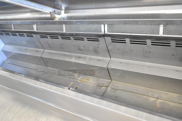 Stainless steel commercial pizza prep table, showing interior condition and shelving, on commercial casters, 115V, 1 phase.