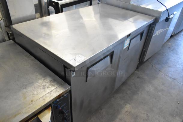 True TUC-48F-LP stainless steel undercounter freezer, 2 doors, 115V, on commercial casters, showing surface wear.