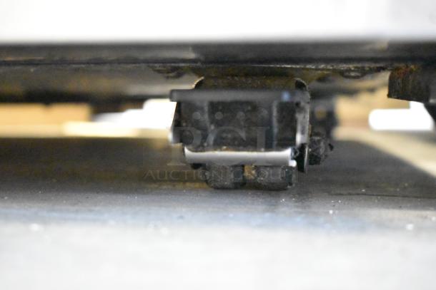 True TUC-48F-LP undercounter freezer caster close-up, showing sturdy commercial wheels. stainless steel frame. 115V, 1 phase.