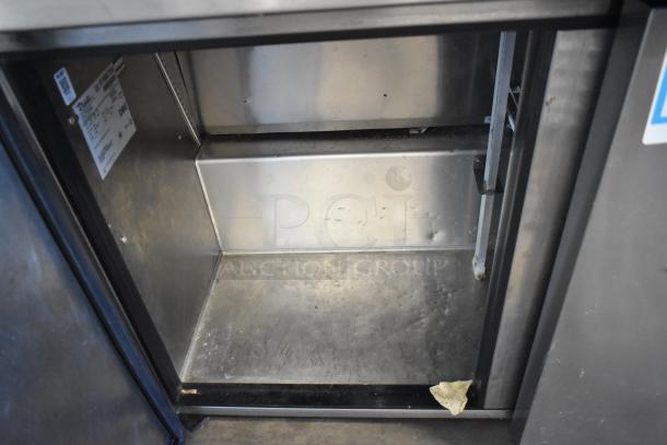 True TUC-48F-LP stainless steel undercounter freezer, two doors, commercial casters, visible interior wear, 115V, 1 phase.