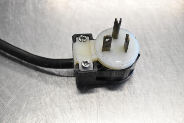 Close-up of the power plug for a True TUC-48F-LP freezer, featuring a durable three-prong design suitable for 115 volts.