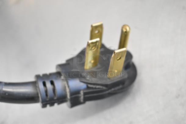 Power plug for Moffat Turbofan E32MS, commercial electric convection oven, featuring gold prongs and black casing.