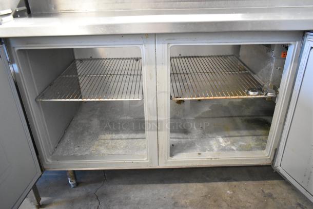 Randell 84111NM stainless steel commercial pizza prep table, used condition, features dual-door access and wire shelving.