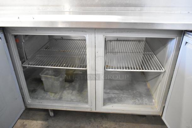 Randell 84111NM stainless steel pizza prep table, 115 volts, 1 phase, with shelving. Used condition.