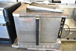 Blodgett stainless steel commercial convection oven, gas-powered, solid doors, metal racks, thermostatic controls, used condition.