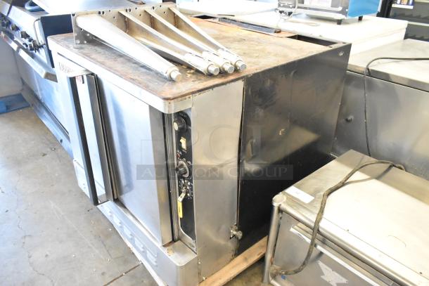 Blodgett stainless steel commercial gas convection oven with solid doors, metal racks, thermostatic controls, and metal legs.