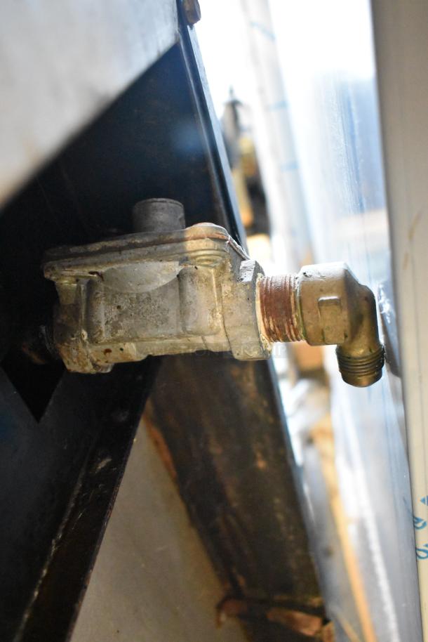 Garland gas connector for commercial griddle, showing moderate wear. Essential for griddle functionality.