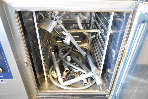 Rational iCombiPro oven interior with stainless steel racks, hoses, and accessories. Model LM100CE.AXXXX. Electric, 3-phase.