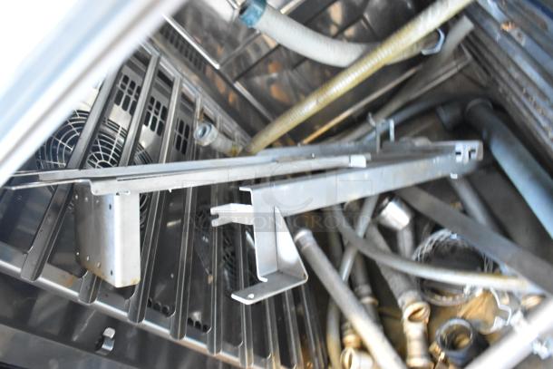 Inside view of 2020 Rational LM100CE.AXXXX/LM100EE.AXXXX convection oven. Stainless steel interior with attachments.