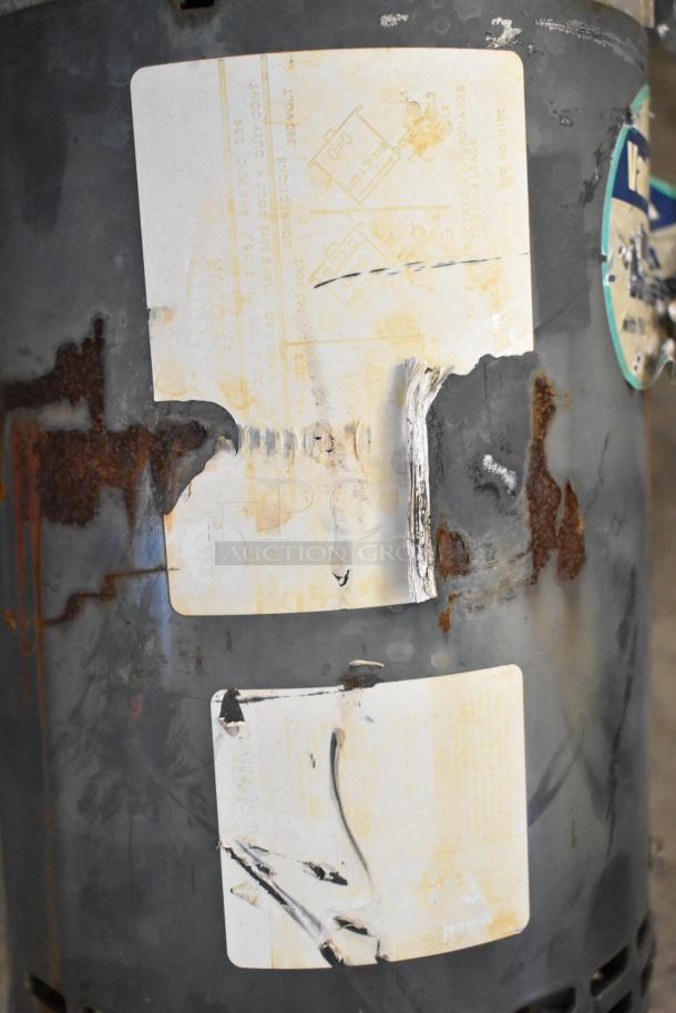 Industrial fan with visible rust and wear, features faded labels with unspecified details; "2 Fans. 2 Times Your Bid!"