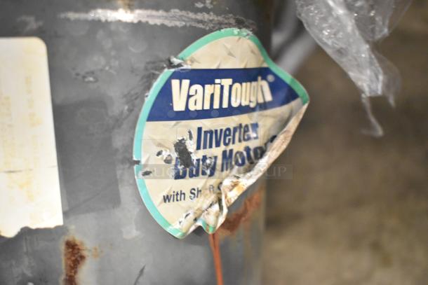 VariTough inverter duty motor with rust and damage visible on label, indicating wear.