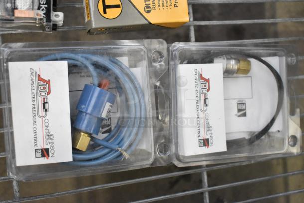 Lot of various items including encapsulated pressure control and Titan Pro run capacitors, packaged in original boxes.