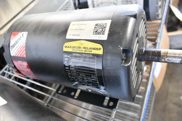 Two Baldor Reliance industrial motors, 460 volts, 3 phase, model 35V870P41AG1, thermally protected, metal casing.