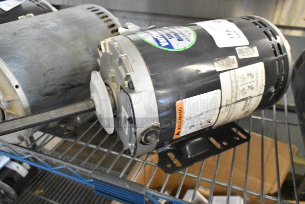 2 US Motors models P63SYABZ-1159 and J63WZBKH-0246, 208/230/460V, 3-Phase on metal shelf, visible labels.