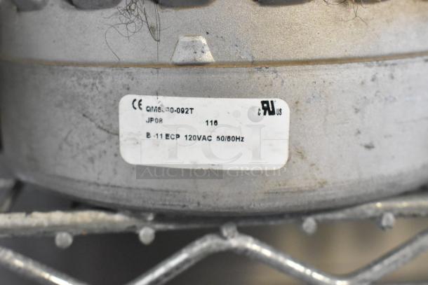 Close-up of a motor with a label showing specifications: 120VAC, 50/60Hz, model B-11 ECP, suitable for industrial use.