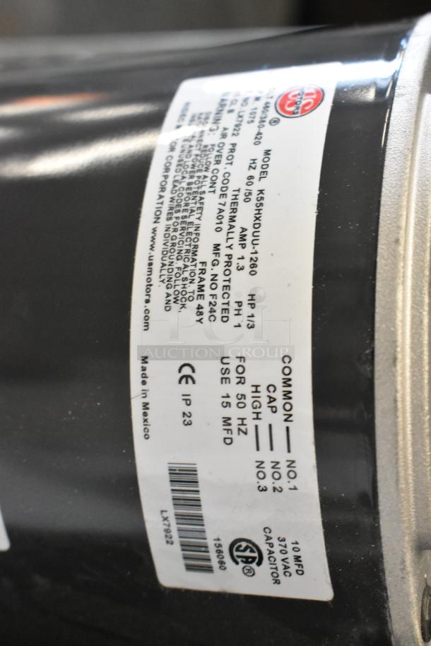 Close-up of a motor label showing specs: Model K55HXDUJ-1260, 380-420/460V, 1 phase, thermally protected, made in Mexico.