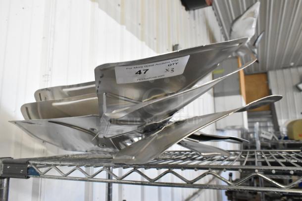 Set of three metallic fan blades on a wire shelf, with label indicating "47 QTY x 3," in clean condition.