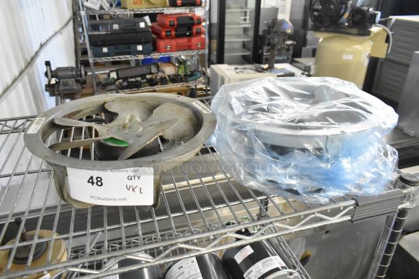 Two fan motors, including US Motors EC5472FP; one is partially wrapped in plastic. Auction tag indicates quantity: 2.