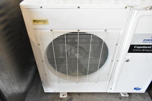 Emerson XFAM-030Z-CFV-081 outdoor refrigeration unit, 208-230 volts, 1 phase. Visible wear, fan grill intact.