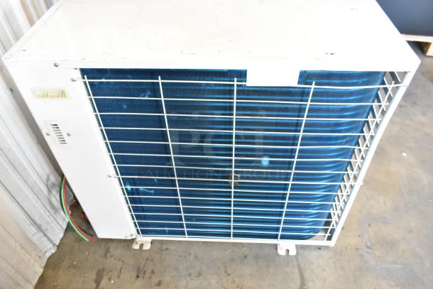 Emerson outdoor refrigeration unit, model XFAM-030Z-CFV-081, 208-230V, 1 phase. Features white casing, visible wiring.