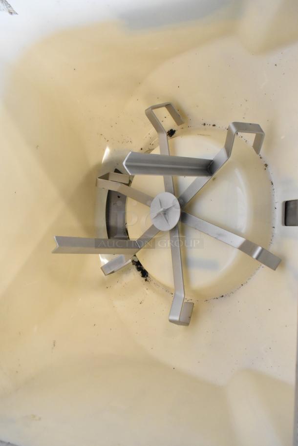 Interior view of Cornelius ED200-BCHZ commercial beverage machine showing stainless steel agitator and base.