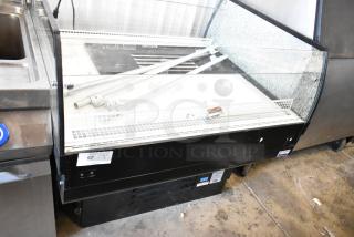 Econocold OM-IRSSCG commercial island fridge with curved glass, on commercial casters, 115V, 1 Phase, minor surface wear.
