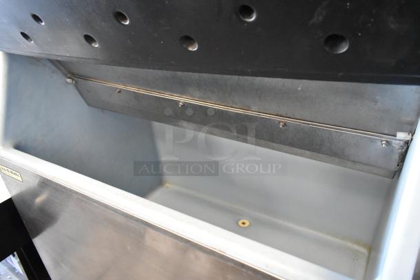 Stainless steel Manitowoc QD0452A commercial ice maker on Ice O Matic bin with casters. 115V, 1 phase, good condition.
