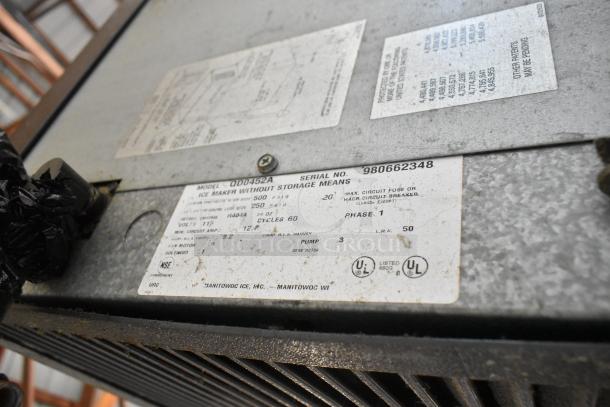 Manitowoc QD0452A stainless steel ice head on Ice O Matic ice bin with label showing 115 volts, 1 phase, serial no. 980662348.