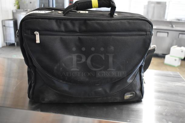 Black Sumdex bag with two front zippers, carrying handle, and visible wear. Contains DTE FS-100 DVCPro.