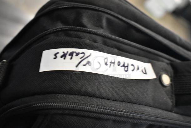 Black bag with handwritten label "DVCPro Cables," part of auction lot including DTE FS-100 DVCPro. Contents not visible.