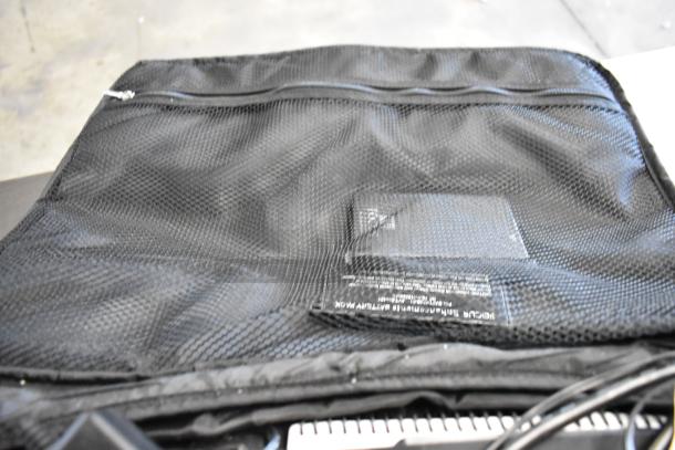 Four various bags containing DTE FS-100 DVCPro equipment. Black mesh bag shown with zip closure and partial label visible.