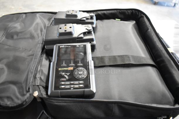 4 bags with contents including DTE FS-100 DVCPro device, in good condition, displayed in a black case.